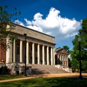 Historic neoclassical university library with columns on a sunny day.
